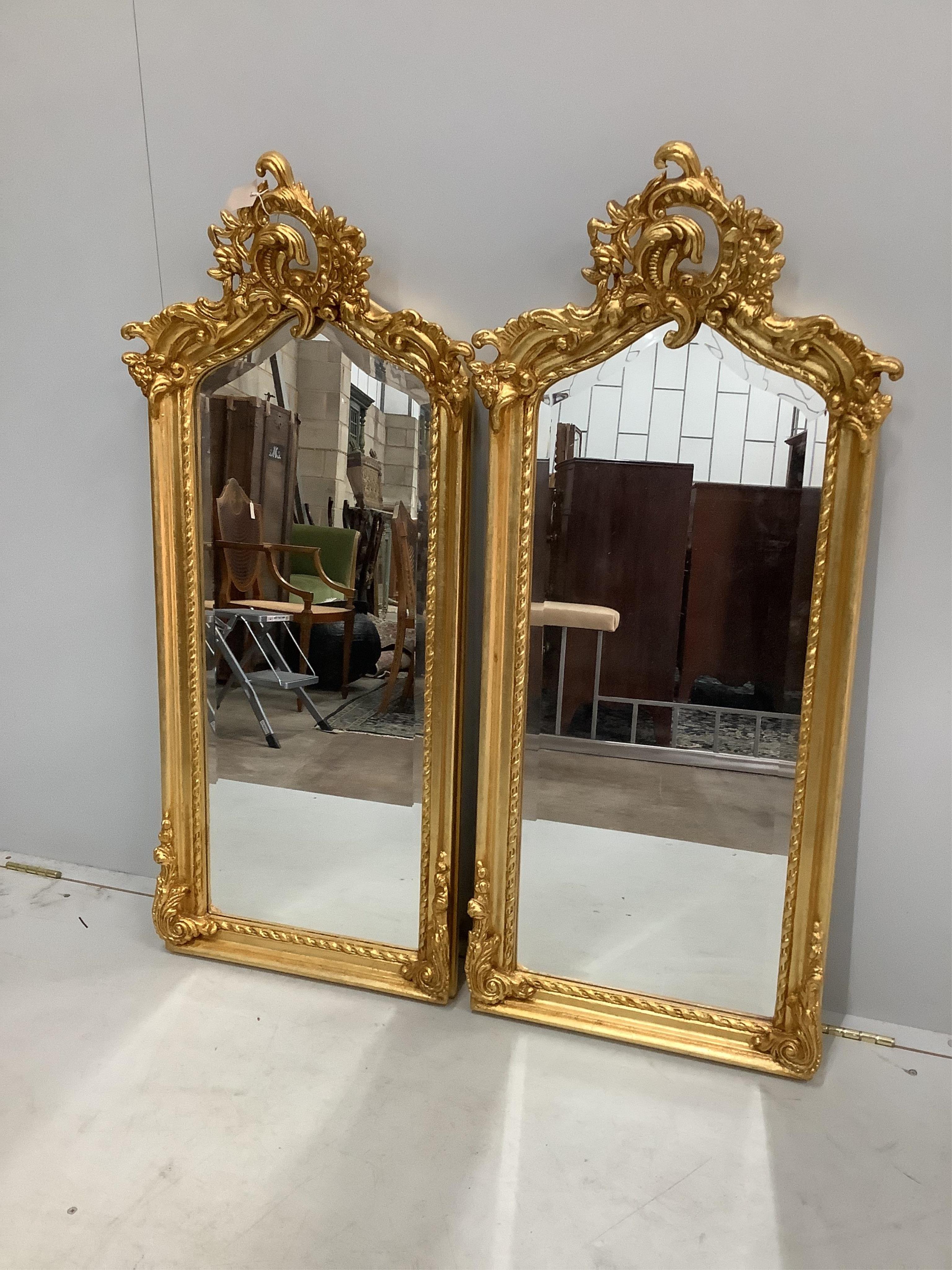 A pair of Victorian style giltwood and composition wall mirrors, width 50cm, height 113cm